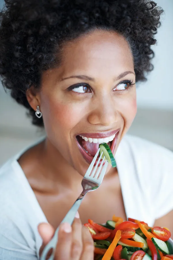 Lipo-Mino-Vitamin-Shot-Treatment A happy black woman eating a healthy salad. Get Lipo-Mino vitamin shots for weight loss from Healthy Aging Medical Centers of New Jersey in Northern New Jersey.