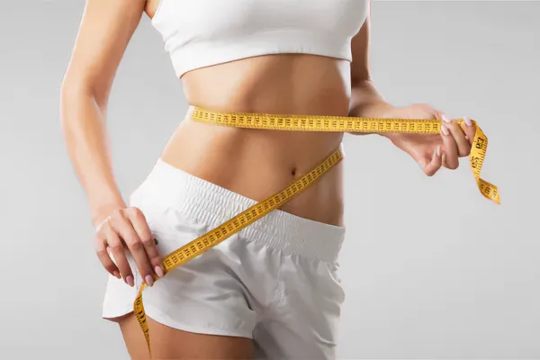 Weight-Loss-Programs-Clinic A woman holds a tape measure around her waist. Schedule signature weight loss programs from Healthy Aging Medical Centers of New Jersey in Northern New Jersey.